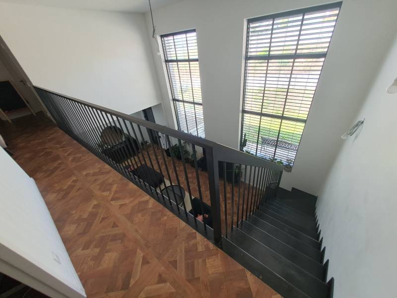 Escalier et garde-corps au style industriel, apportant finesse et modernité à l’intérieur de la maison