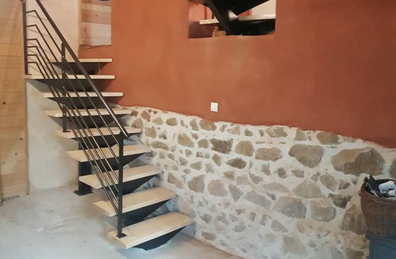 Escalier ½ tournant avec limon central en acier et marches en frêne blanc vitrifié, conçu et fabriqué par ASMT Design.